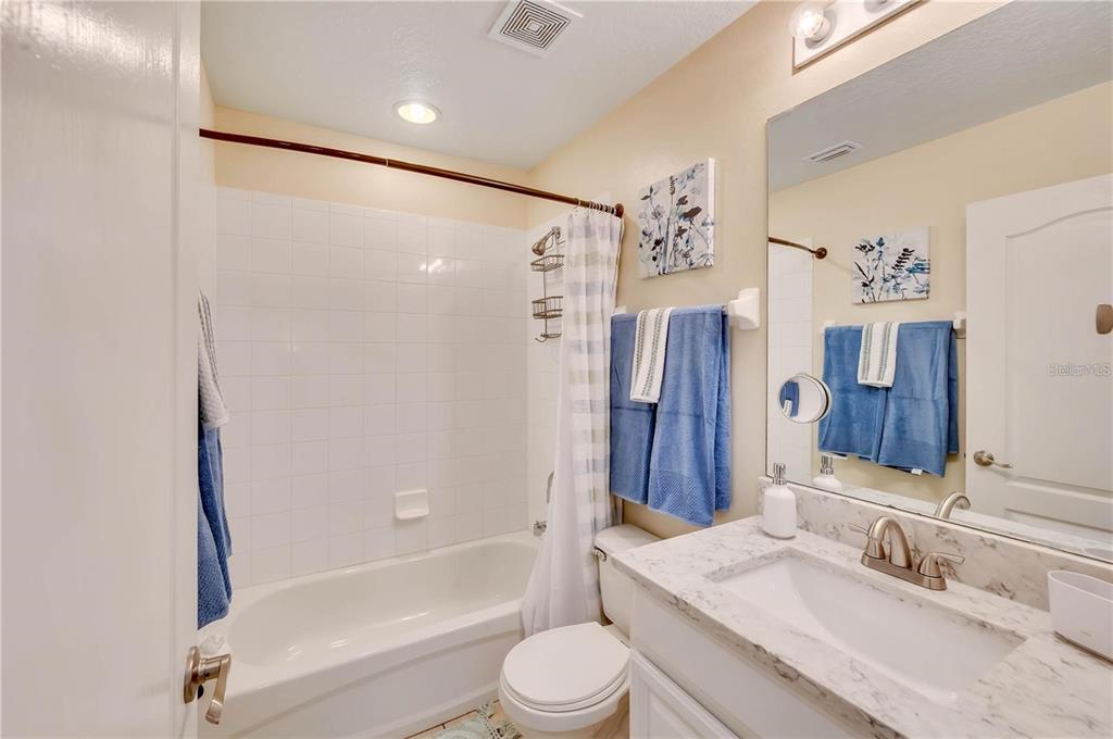 280 Cape Harbour Loop, Unit 101 Bradenton, FL 34212 - Photo 19 of 35 a bathroom with a granite countertop sink toilet and shower