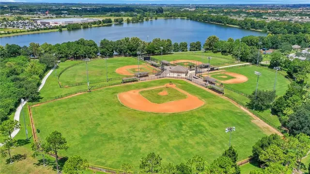 an aerial view of a residential houses with outdoor space and lake view