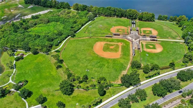 an aerial view of a house with a swimming pool patio and lake view
