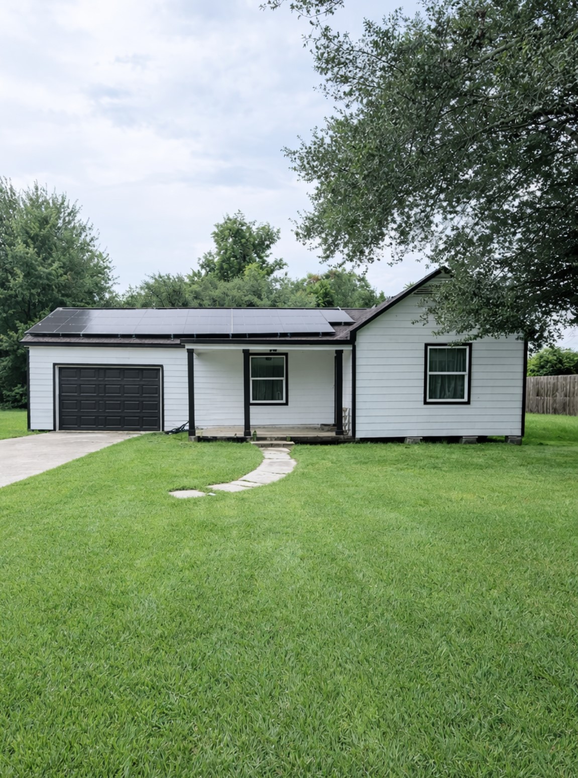 801 Trinity Street Anahuac, TX 77514 - Photo 1 of 9 a view of a house with a yard and a large tree
