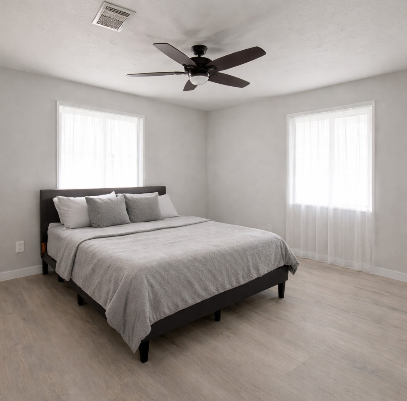 801 Trinity Street Anahuac, TX 77514 - Photo 3 of 9 a bedroom with a bed and window