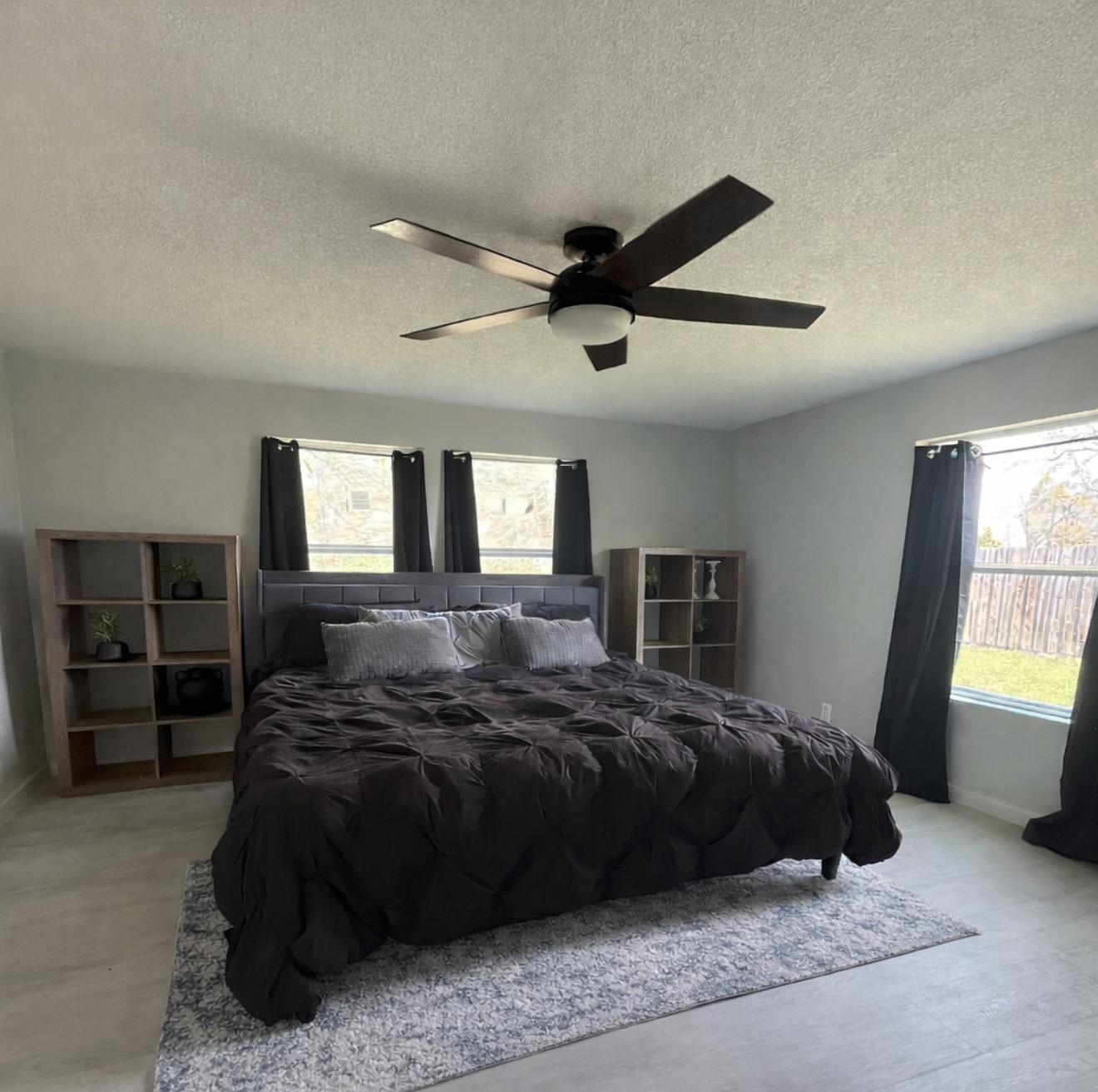 801 Trinity Street Anahuac, TX 77514 - Photo 6 of 9 a bedroom with a bed a window and dresser