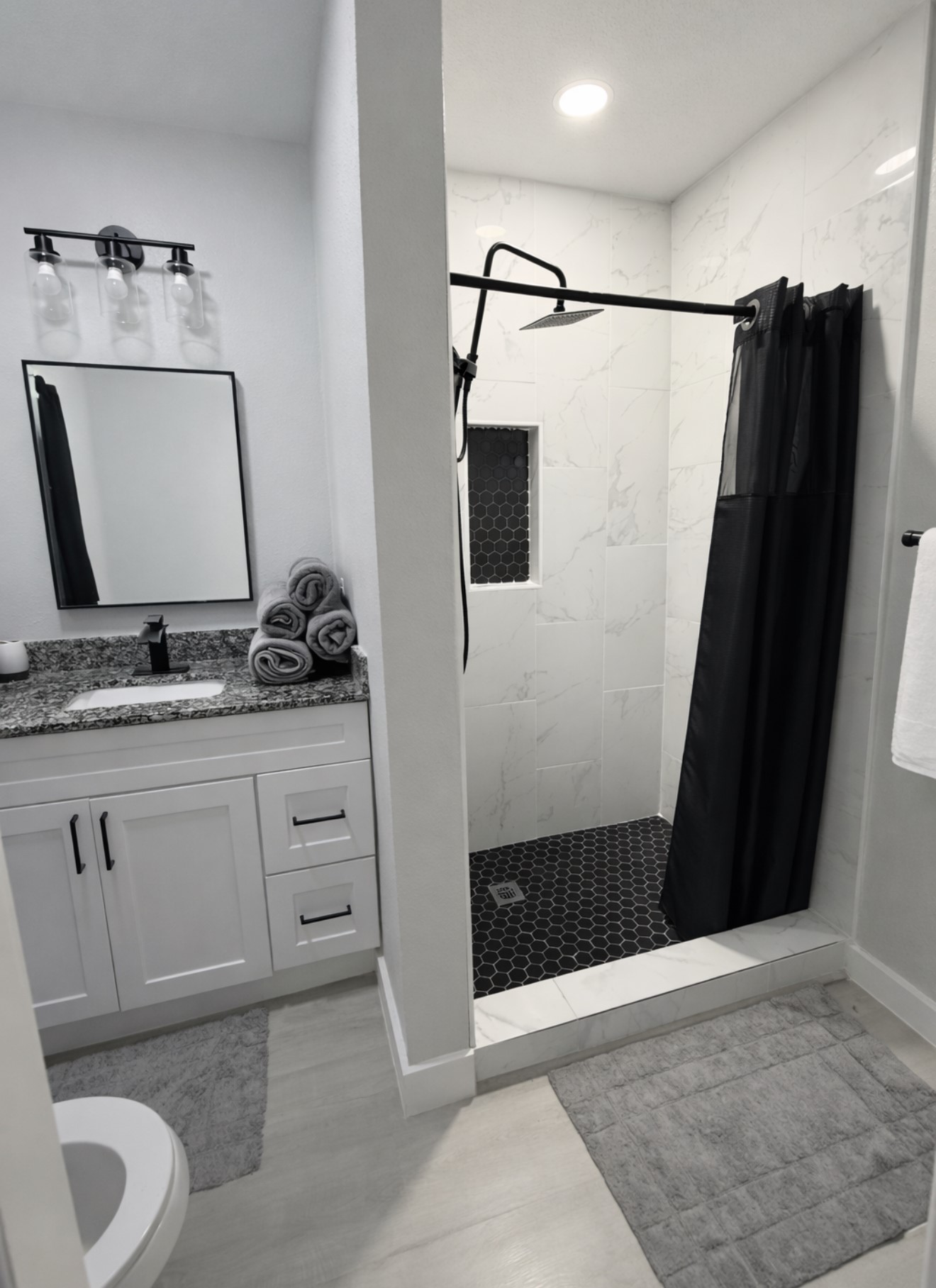 801 Trinity Street Anahuac, TX 77514 - Photo 7 of 9 a bathroom with a sink and a mirror