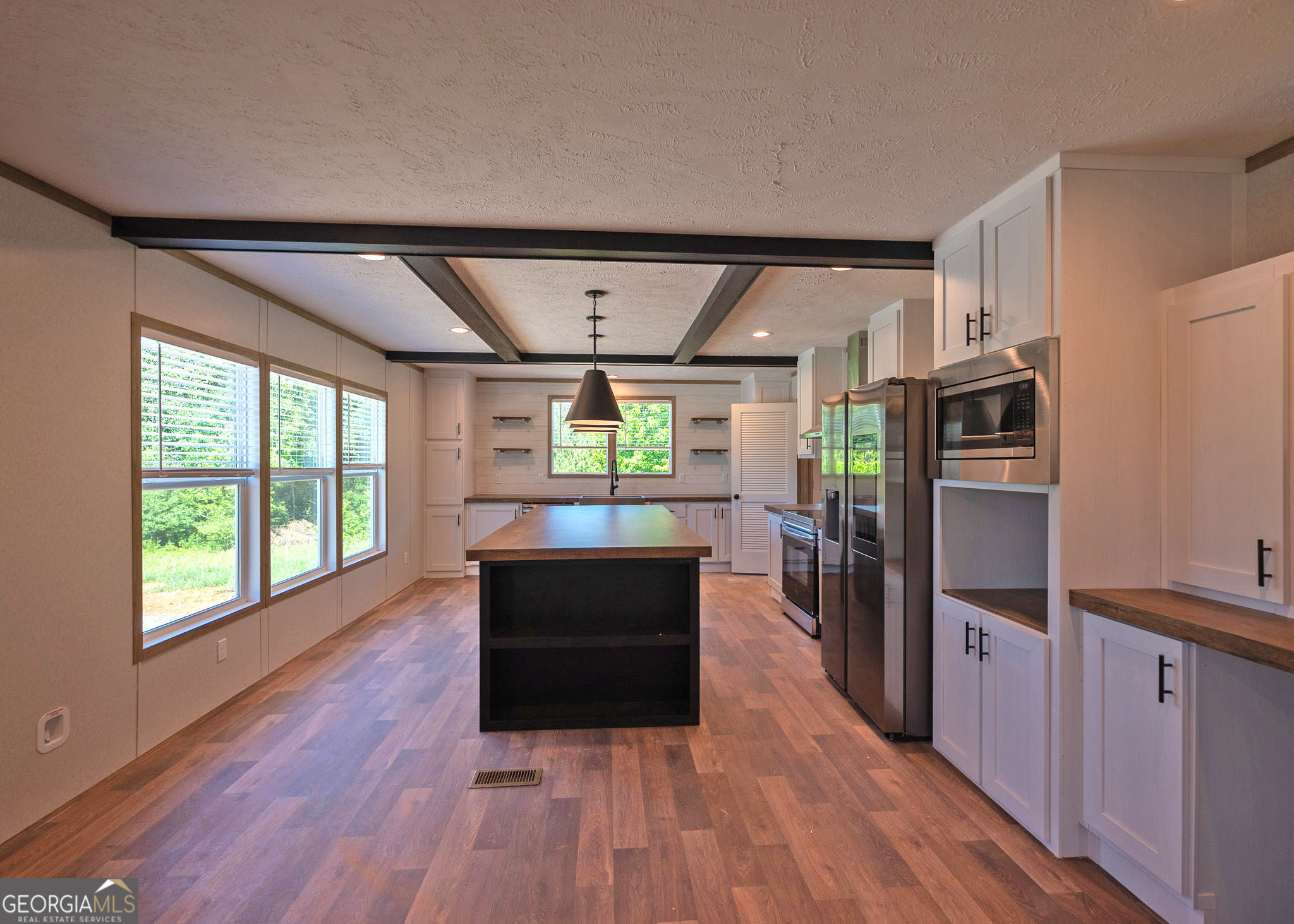413 Griffin Road Martin, GA 30557 - Photo 8 of 31 a kitchen with stainless steel appliances granite countertop a refrigerator a stove and a wooden floors