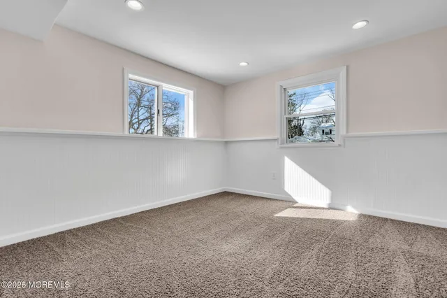 a view of a bathroom with wooden floor and a toilet