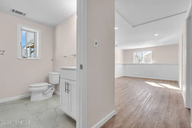 a bathroom with a sink toilet and a mirror
