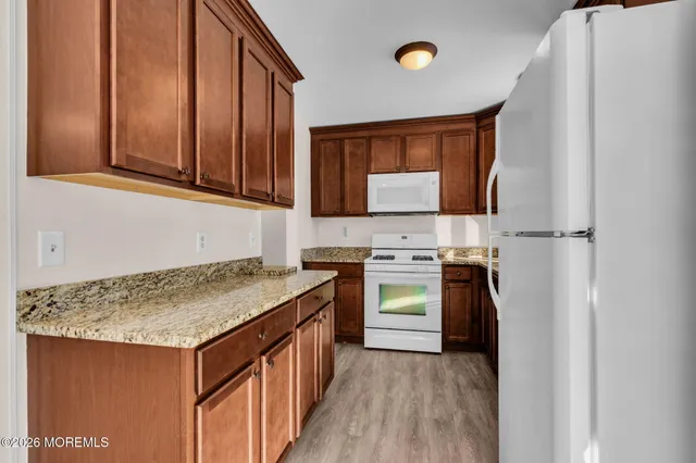 a kitchen with a sink stove and refrigerator