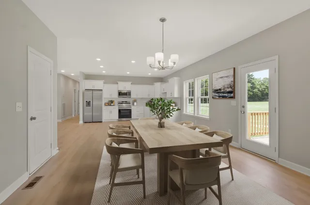 a view of a dining room with furniture window and wooden floor