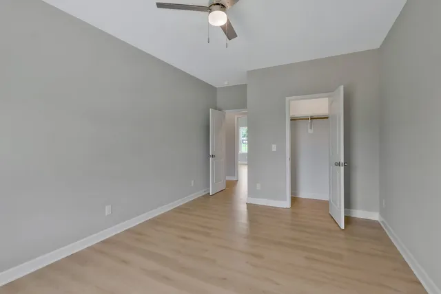 a view of an empty room with wooden floor
