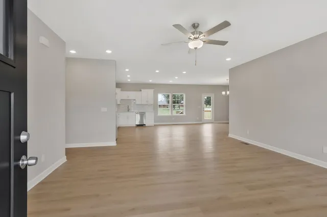 a view of an empty room with a ceiling fan