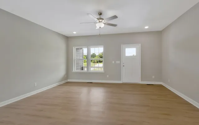 wooden floor in an empty room with a window