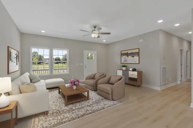 a living room with furniture and a chandelier