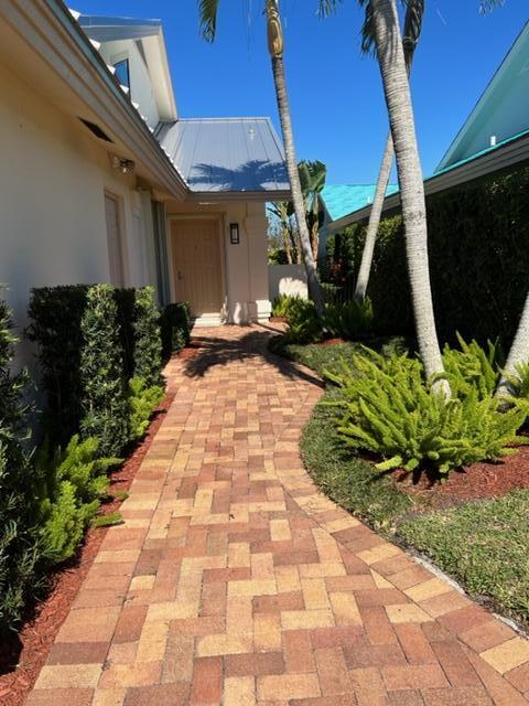 400 River Edge Road Jupiter, FL 33477 - Photo 3 of 19 a view of a pathway with flower plants