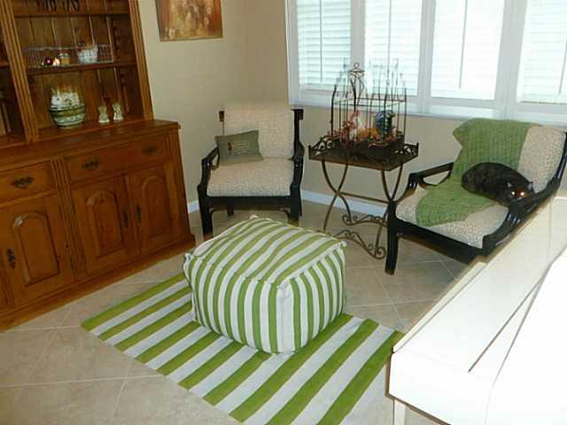 150 Southwest Walking Path Stuart, FL 34997 - Photo 12 of 25 a balcony with chairs and a rug