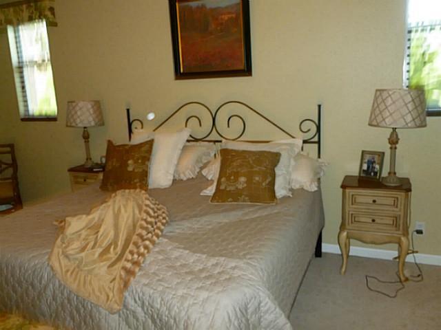 150 Southwest Walking Path Stuart, FL 34997 - Photo 16 of 25 a bedroom with a bed and furniture