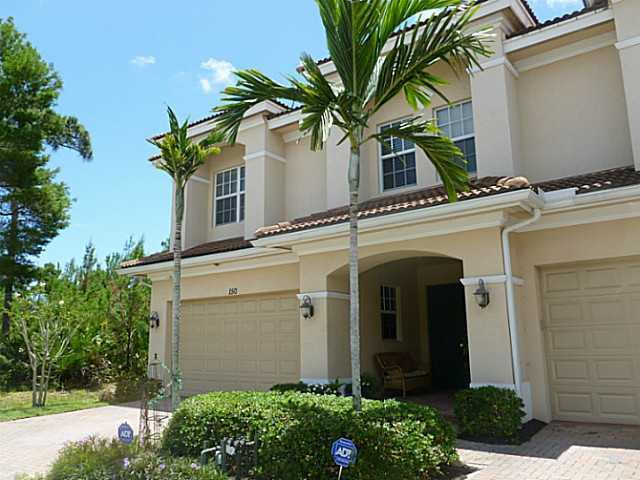 150 Southwest Walking Path Stuart, FL 34997 - Photo 2 of 25 a front view of a house with a yard