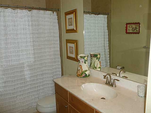 150 Southwest Walking Path Stuart, FL 34997 - Photo 22 of 25 a bathroom with a sink a toilet and mirror