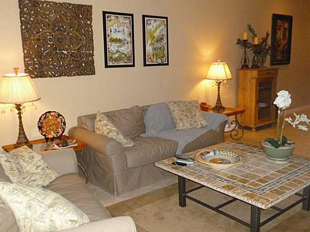 150 Southwest Walking Path Stuart, FL 34997 - Photo 6 of 25 a living room with a couch and a lamp