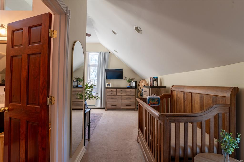 374 Hill Road Jeffersonville, NY 12748 - Photo 13 of 36 Carpeted bedroom with a nursery area and vaulted ceiling