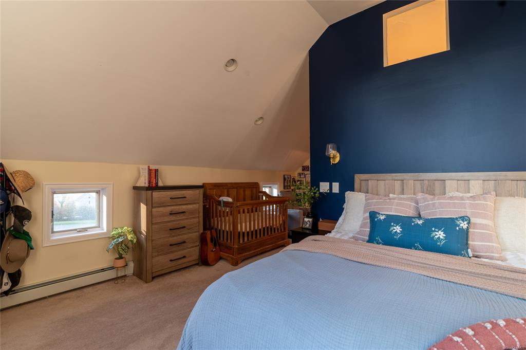 374 Hill Road Jeffersonville, NY 12748 - Photo 15 of 36 Carpeted bedroom with a baseboard radiator and vaulted ceiling