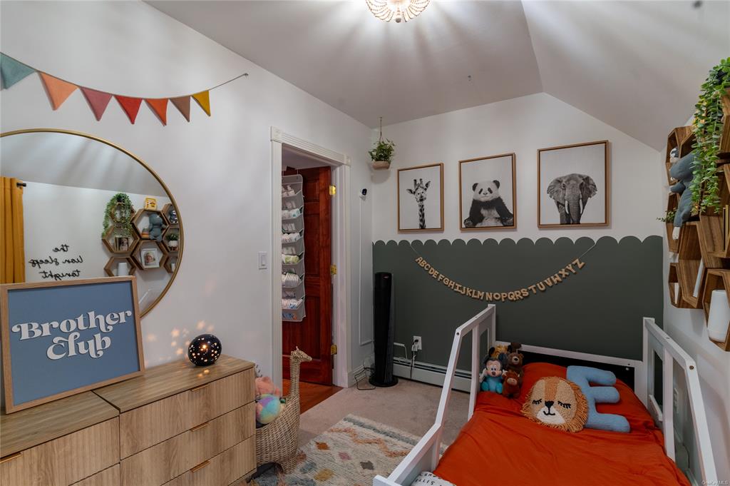 374 Hill Road Jeffersonville, NY 12748 - Photo 20 of 36 Carpeted bedroom featuring vaulted ceiling and a baseboard heating unit