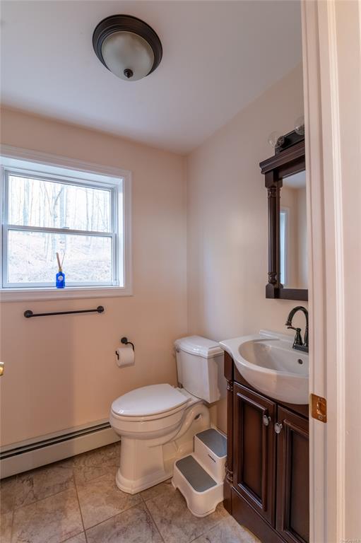 374 Hill Road Jeffersonville, NY 12748 - Photo 21 of 36 Bathroom featuring tile patterned flooring, vanity, toilet, and baseboard heating