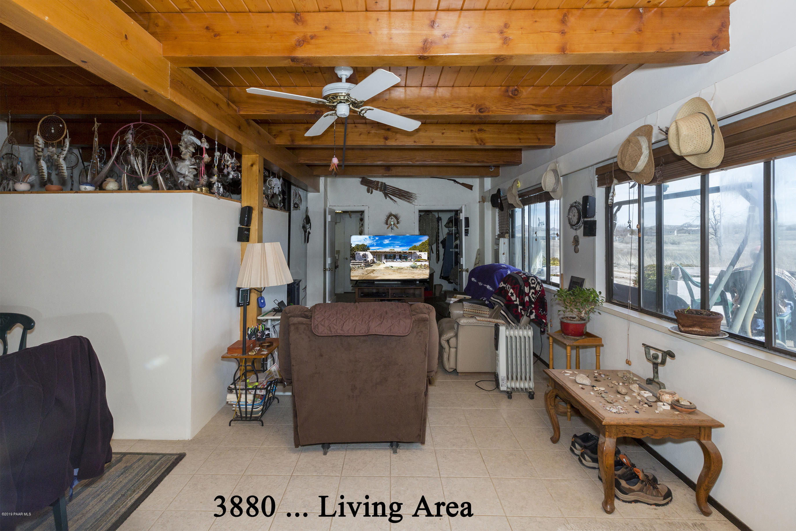 3880-3884 North Reed Road Chino Valley, AZ 86323 - Photo 19 of 30 a living room with furniture a flat screen tv and a window