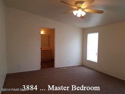 3880-3884 North Reed Road Chino Valley, AZ 86323 - Photo 9 of 30 an empty room with windows and fan