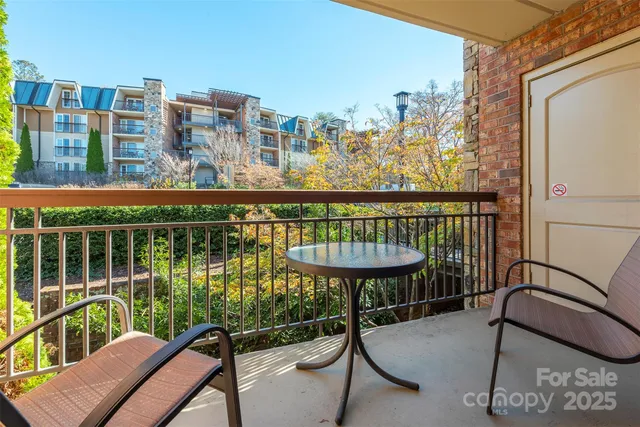 a view of a balcony with two chairs and a table
