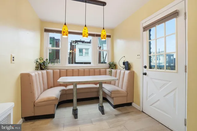 a living room with furniture a window and a chandelier