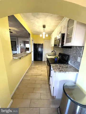 a kitchen with stainless steel appliances granite countertop a sink and a stove