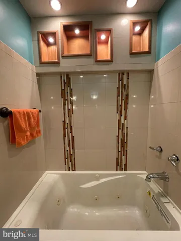 a bathroom with a bathtub and a shower
