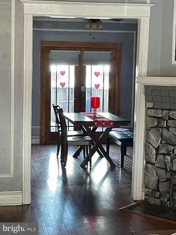 a dining room with furniture and wooden floor