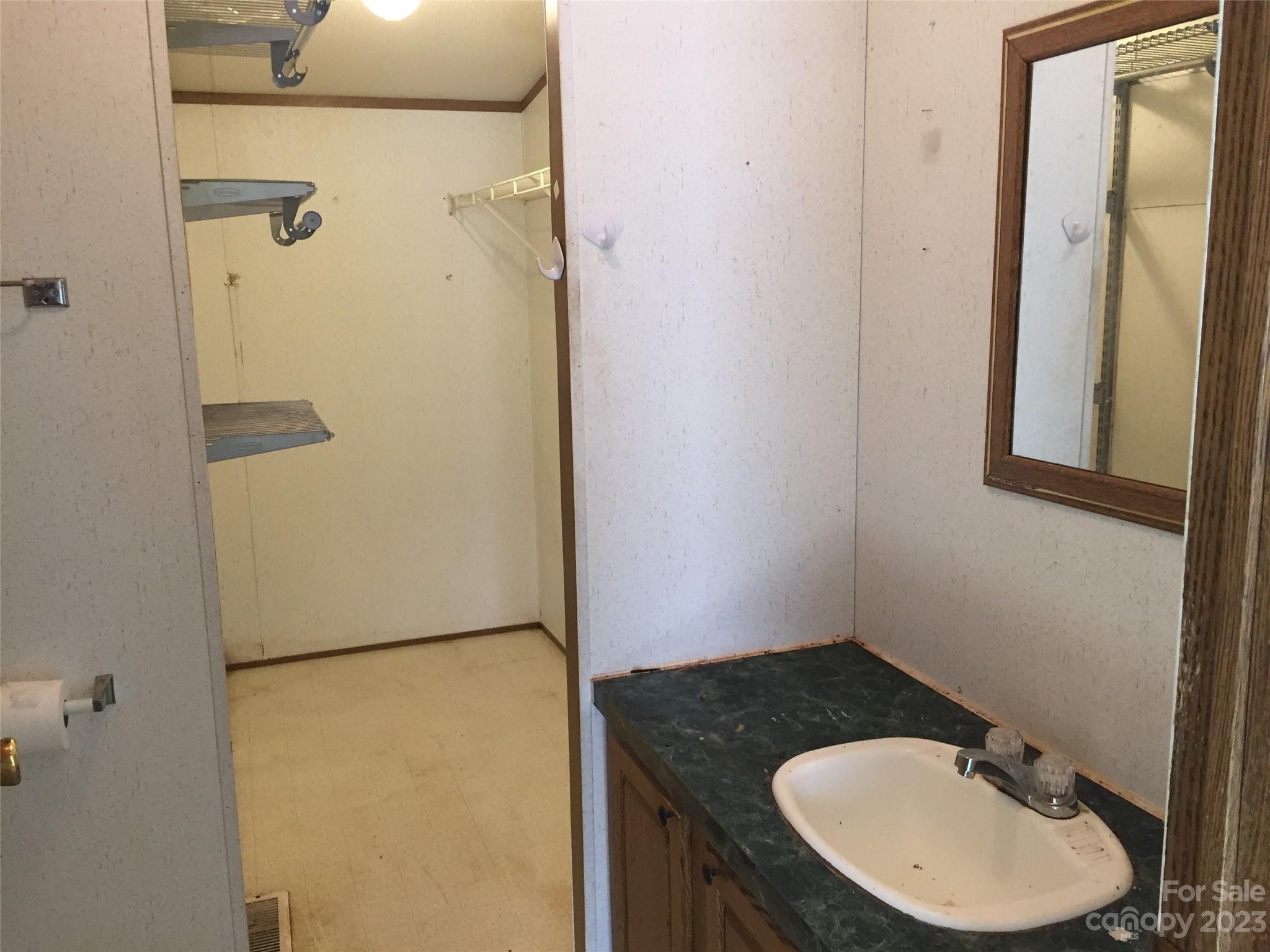 171 Charlie Randall Road Lawndale, NC 28090 - Photo 11 of 28 a bathroom with a sink and mirror