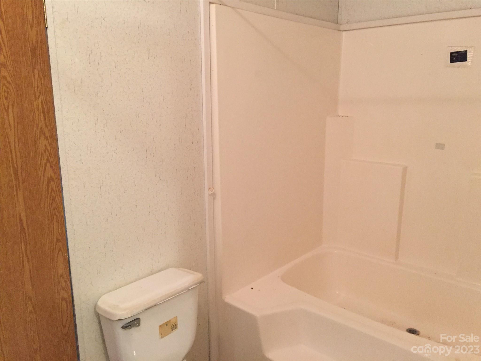 171 Charlie Randall Road Lawndale, NC 28090 - Photo 12 of 28 a bathroom with a toilet and a bathtub