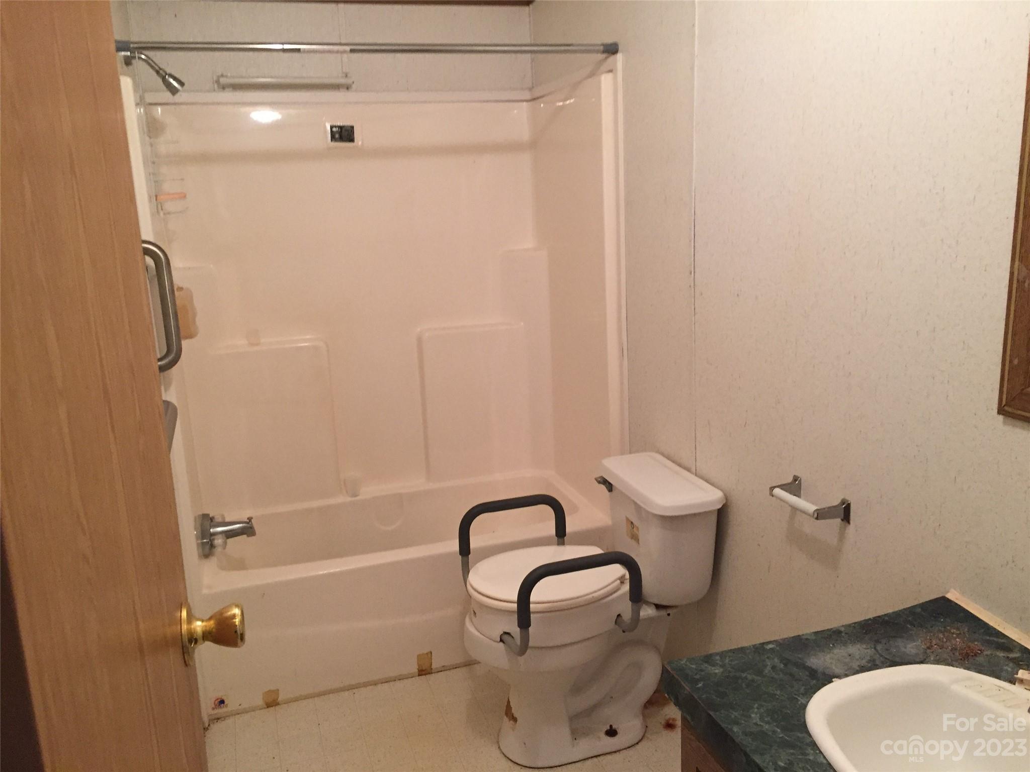 171 Charlie Randall Road Lawndale, NC 28090 - Photo 14 of 28 a bathroom with a granite countertop toilet sink and shower