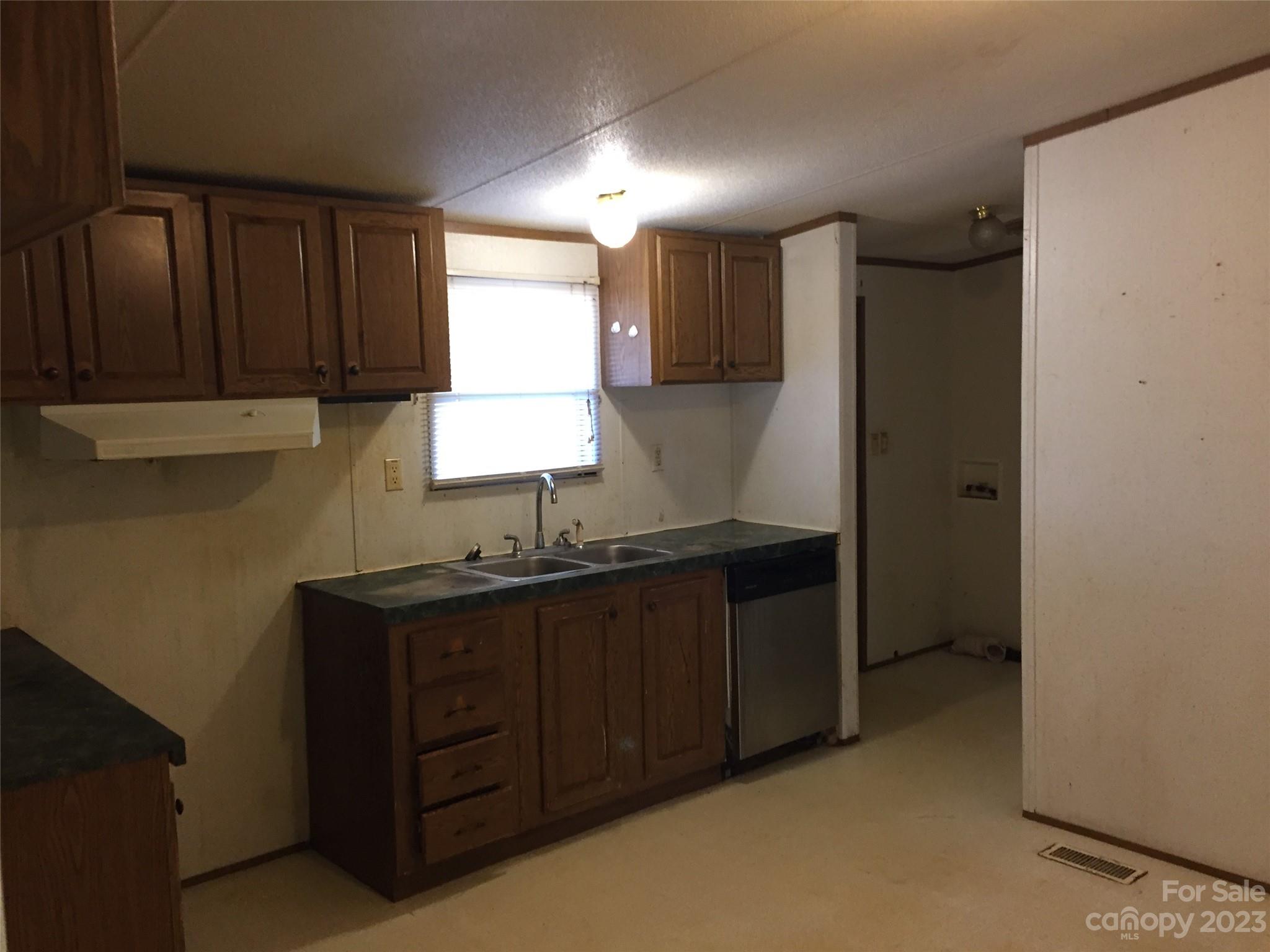 171 Charlie Randall Road Lawndale, NC 28090 - Photo 6 of 28 a kitchen with a sink a refrigerator and window