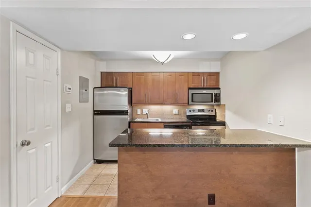 a view of a kitchen with a sink stove and refrigerator