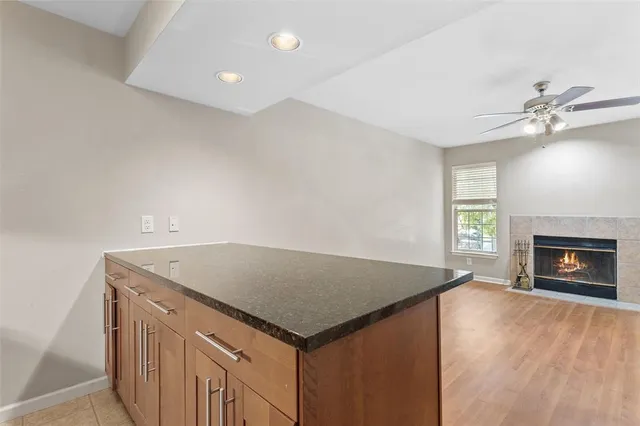 an empty room with a fireplace and fan
