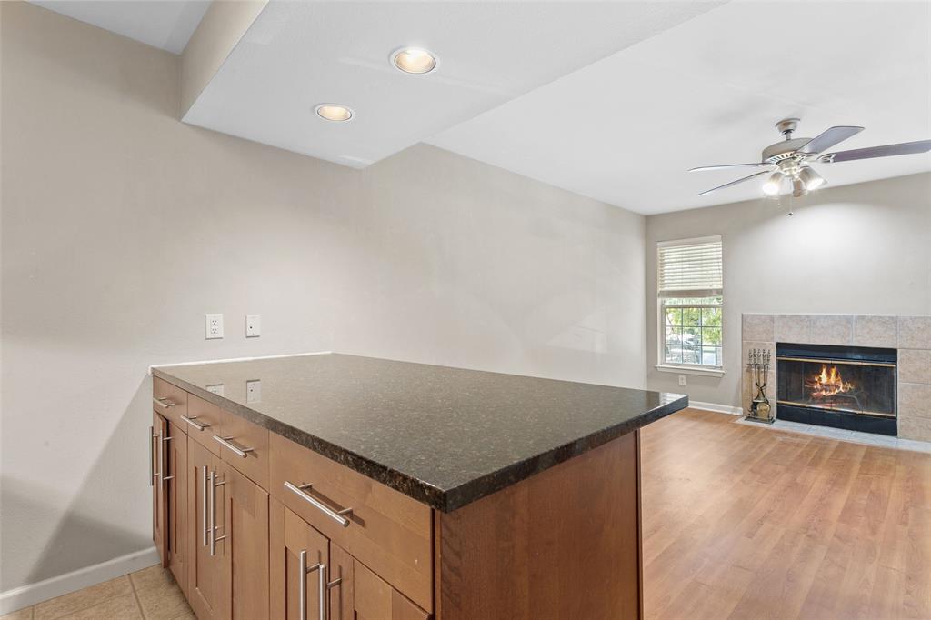 7685 Northcross Drive, Unit 423 Austin, TX 78757 - Photo 12 of 20 an empty room with a fireplace and fan