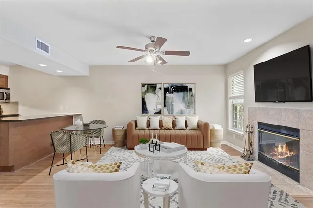 a living room with fireplace furniture and a flat screen tv