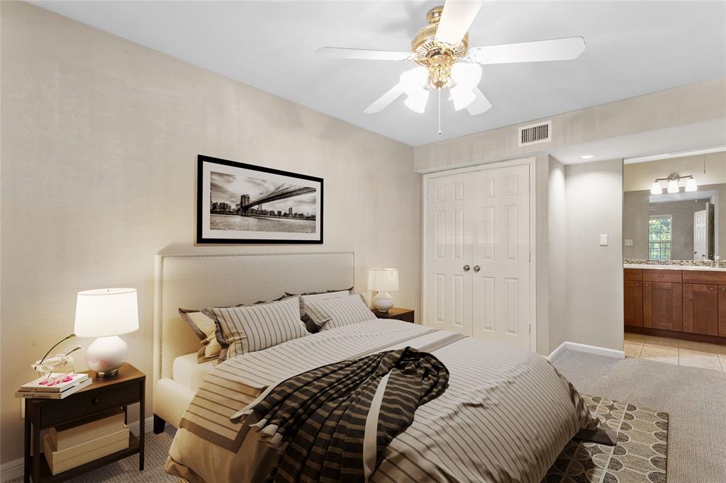 7685 Northcross Drive, Unit 423 Austin, TX 78757 - Photo 4 of 20 a bedroom with a bed and a chandelier