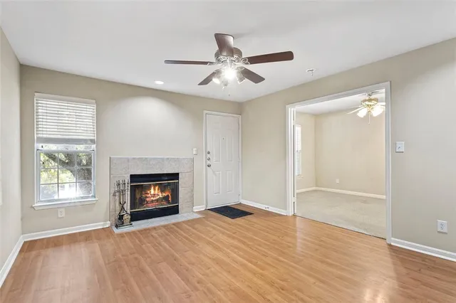 a view of an empty room with fire place and a fireplace