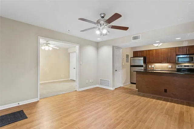 a view of a kitchen with a sink and a refrigerator