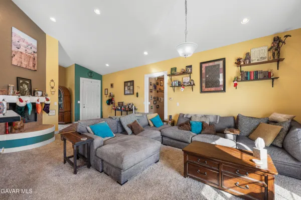 a living room filled with furniture and a flat screen tv