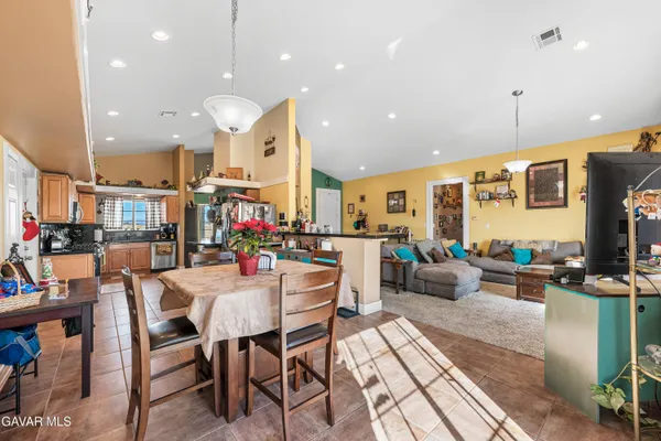 a living room with dining room and kitchen view