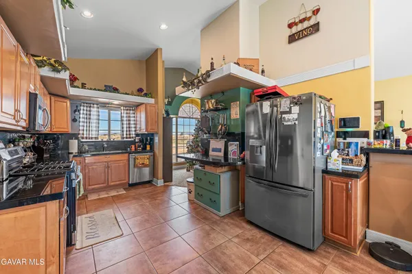a kitchen with stainless steel appliances granite countertop a refrigerator and a stove