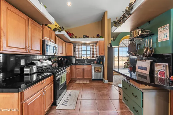 a kitchen with stainless steel appliances granite countertop a stove and a sink