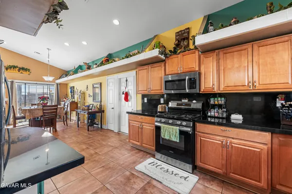 a kitchen with stainless steel appliances granite countertop a stove sink and cabinets