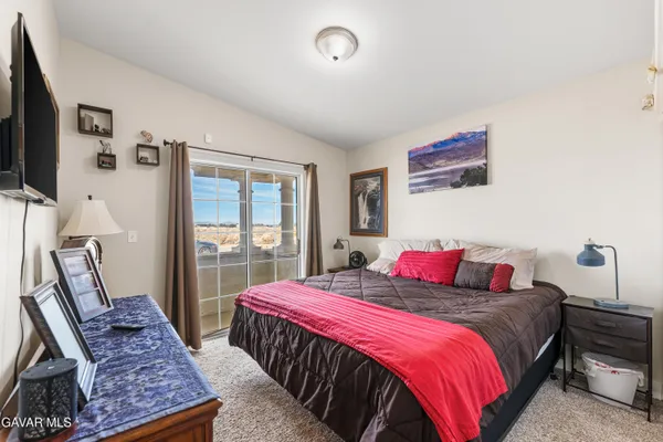 a bedroom with double bed and a flat screen tv